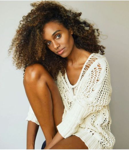 Gelila Bekele in a white dress poses a picture for a photoshoot.